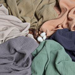 Lulumoon olive muslin blanket with baby cuddling for naps