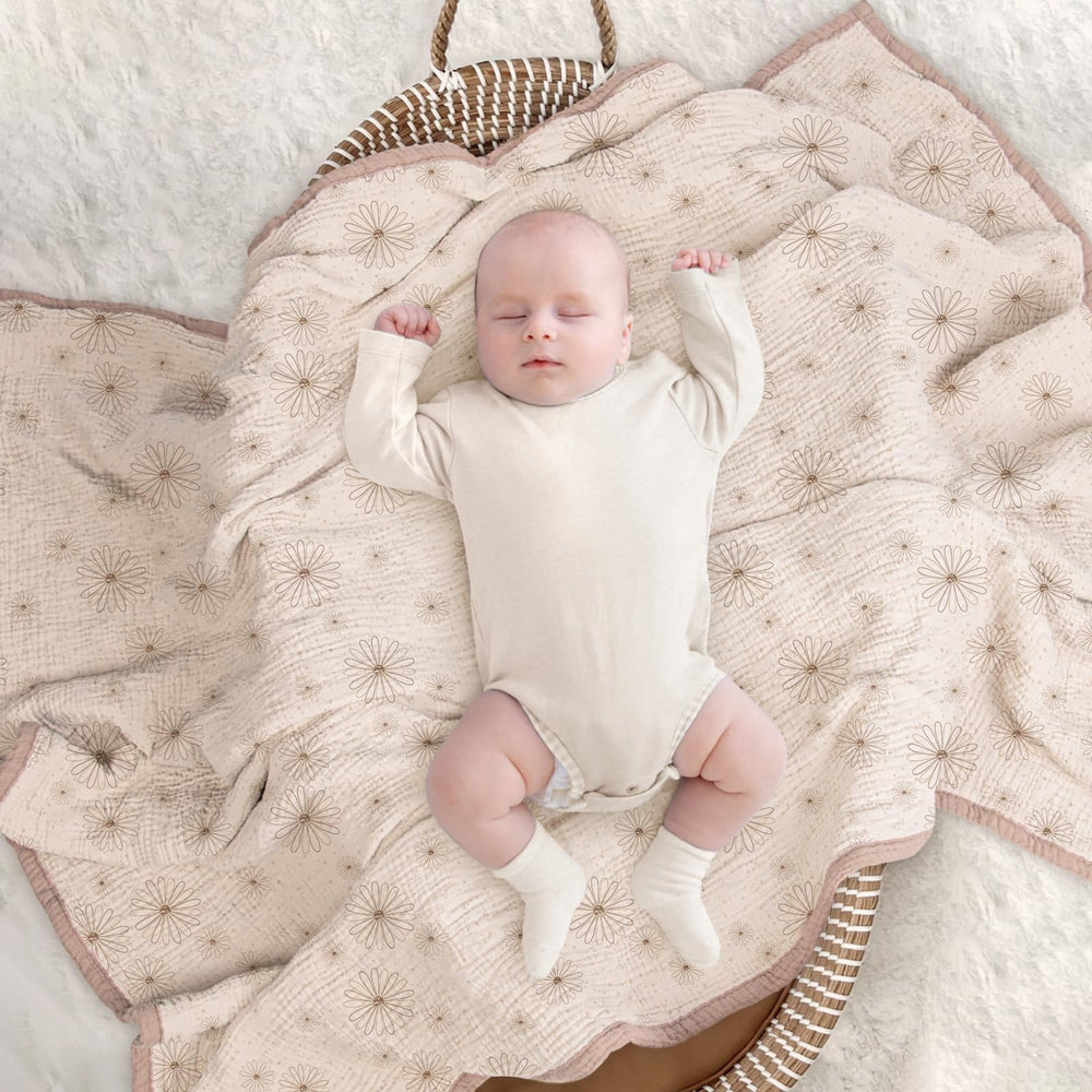 Lulumoon muslin blanket Sand Daisy folded with toys suggests easy care and versatility