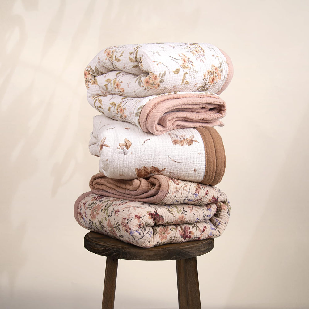 Lulumoon muslin blanket on stroller as sun shield, handy for outings.