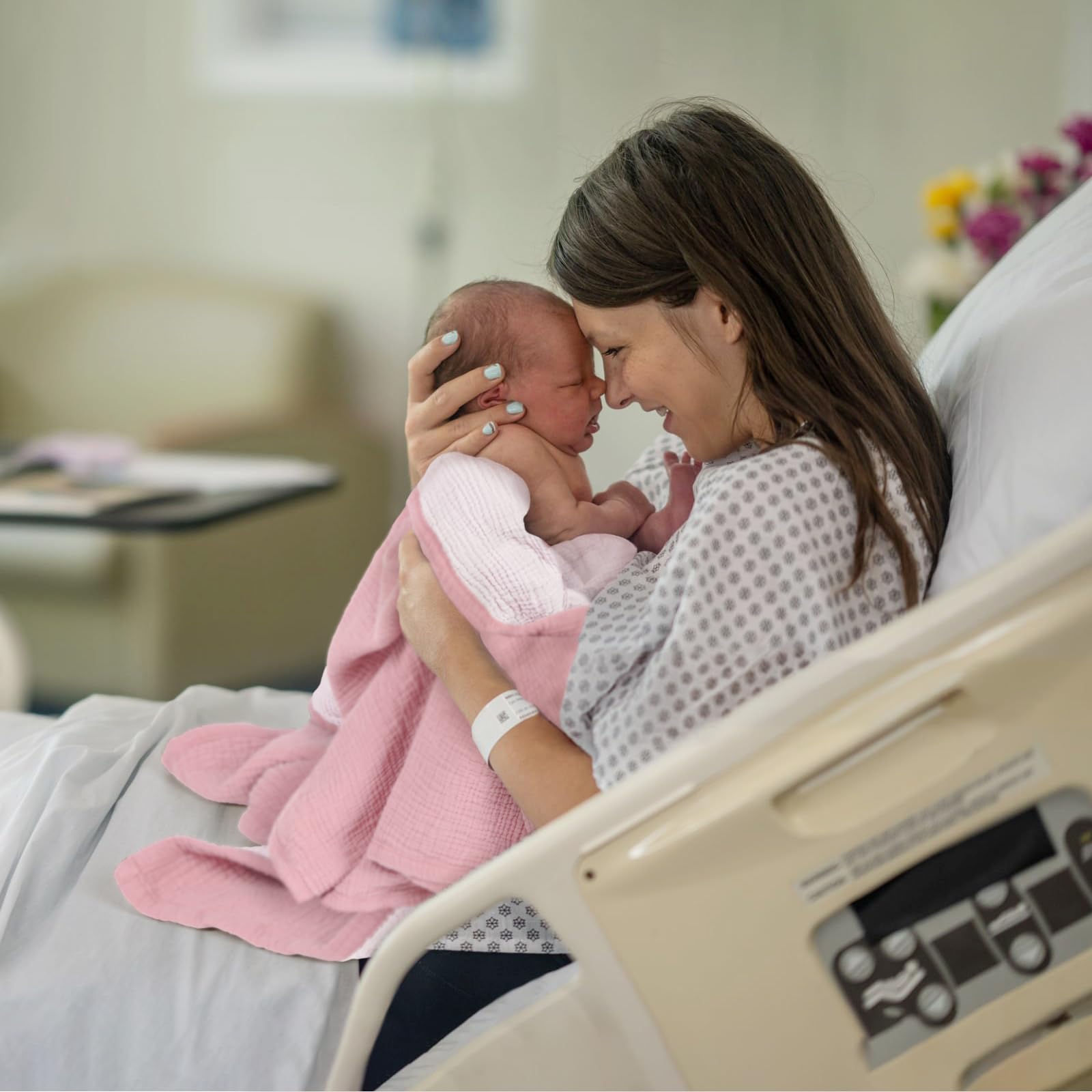 Lulumoon muslin blanket folded as a gentle swaddle for newborns.