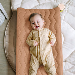 Lulumoon muslin changing pad cover highlighting elastic band for secure fit.