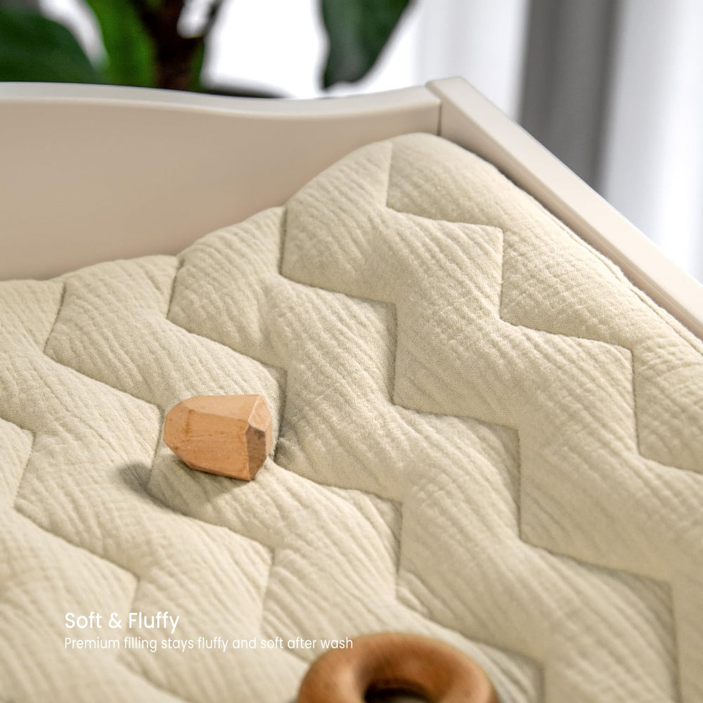 Lulumoon muslin changing pad cover with safety belt holes for quick adjustments.