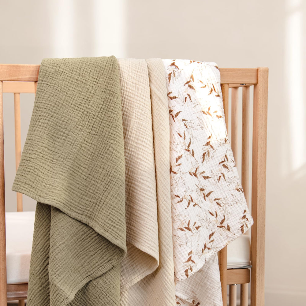 lulumoon muslin swaddle olive branches folded for easy hospital swaddling and secure snug wrap.