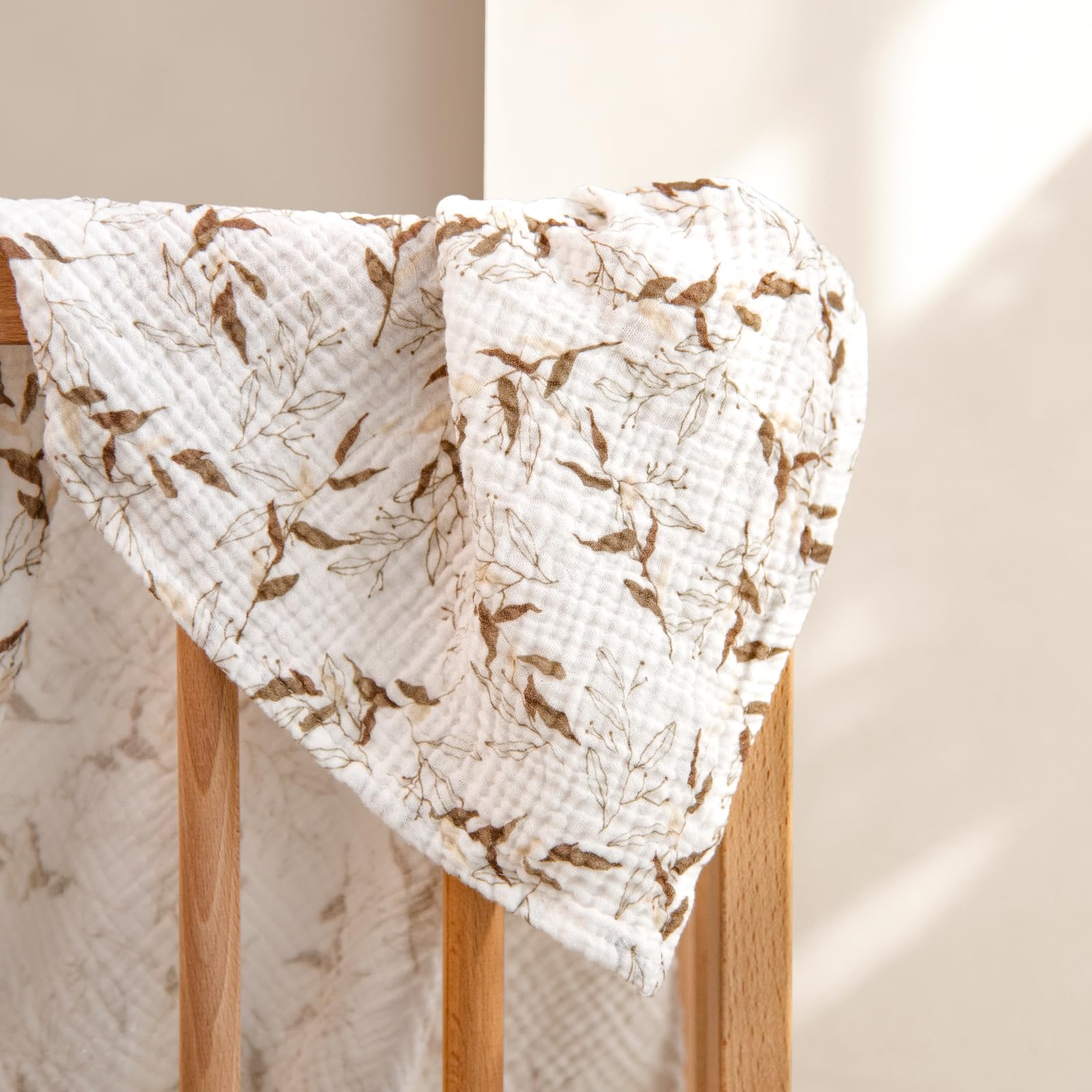 lulumoon muslin swaddle olive branches laid out for baby care routines and quick diaper changes.