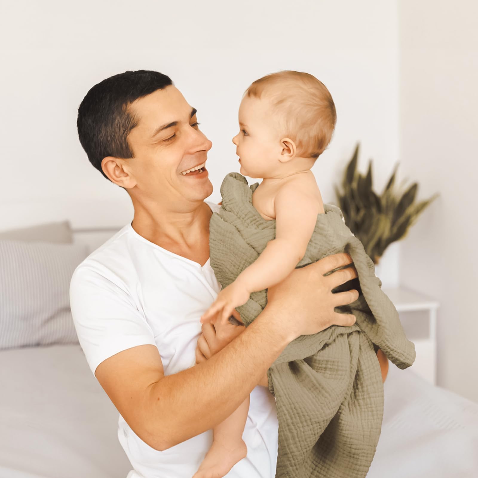 lulumoon muslin swaddle olive branches being machine washed to reveal extra softness.