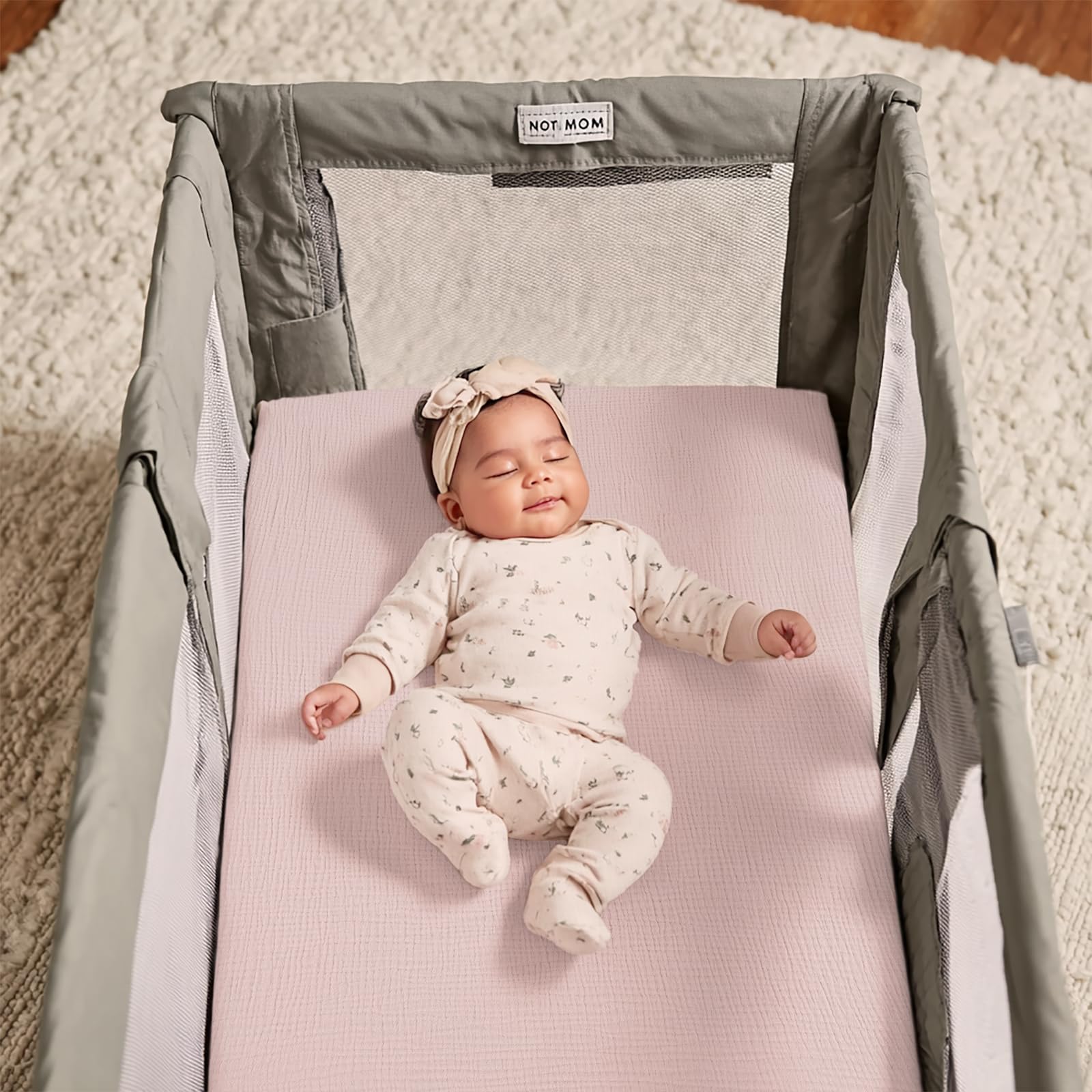 lulumoon nursery setup with pink pack and play sheets