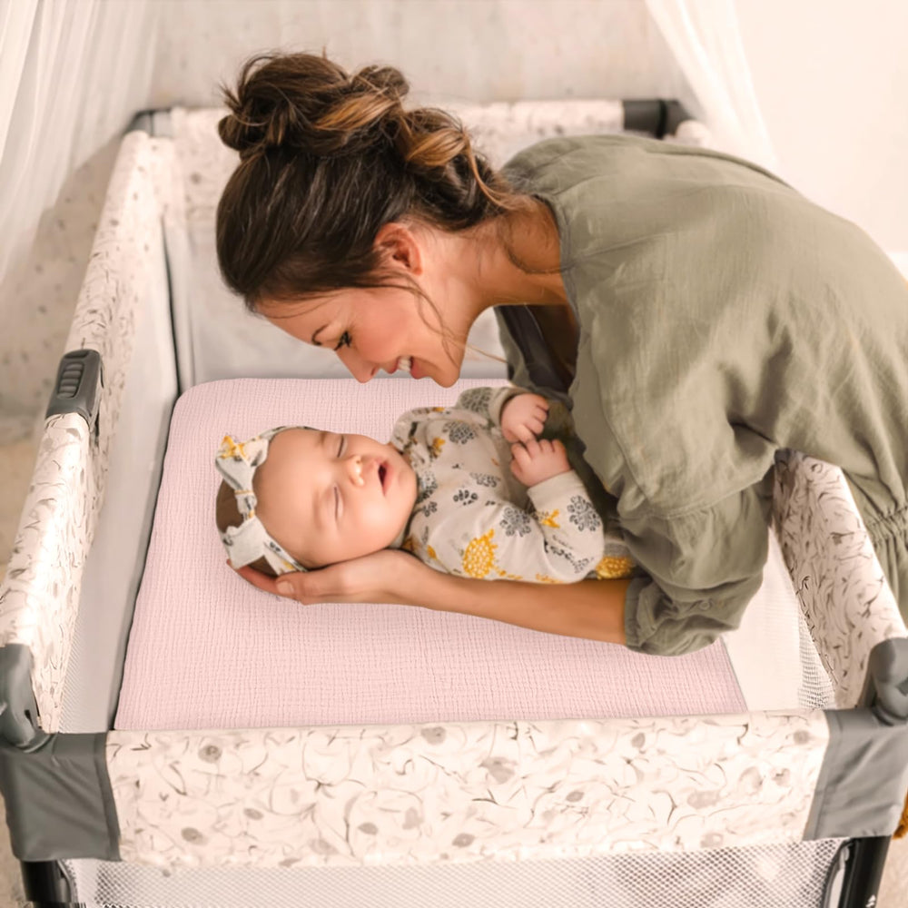 lulumoon pink-toned pack and play sheets enhance nursery decor