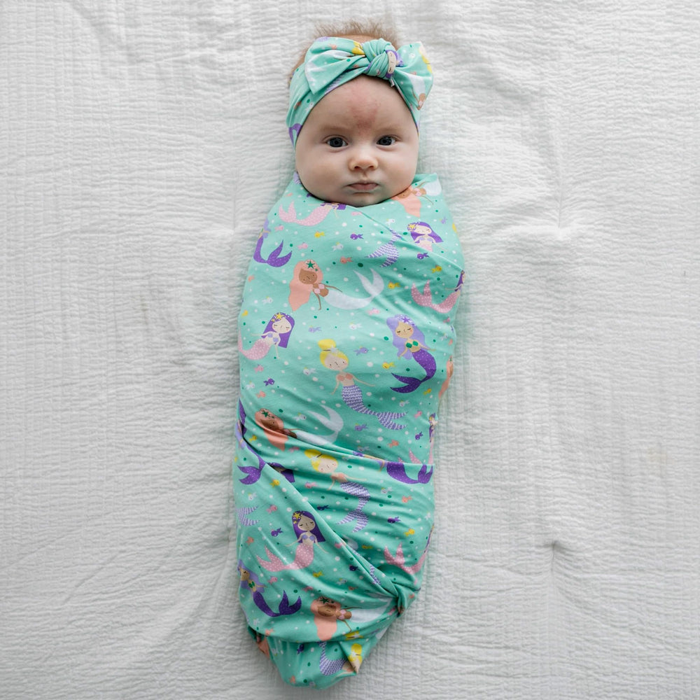 Lunaluxe bamboo swaddle fabric close-up showing silky softness and breathability