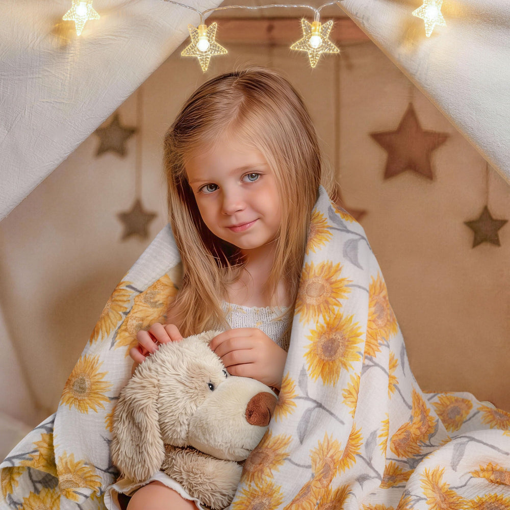 Unfolded blanket laid flat shows generous 38x40 inch size for growing babies.