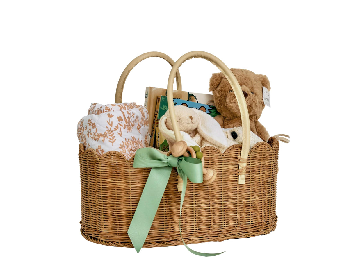 Mae Bird rattan diaper caddy with handles, front view shows natural weave for tidy nursery organization.