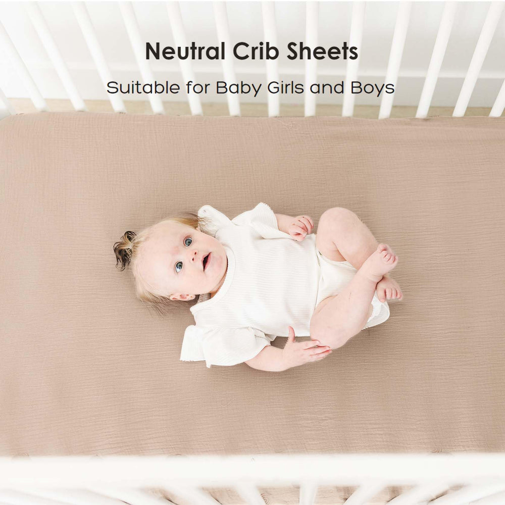 MairMore muslin crib sheet ash shown with baby sleeping on crib.