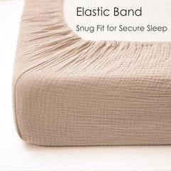MairMore muslin crib sheet close-up elastic edge demonstrates secure fit.