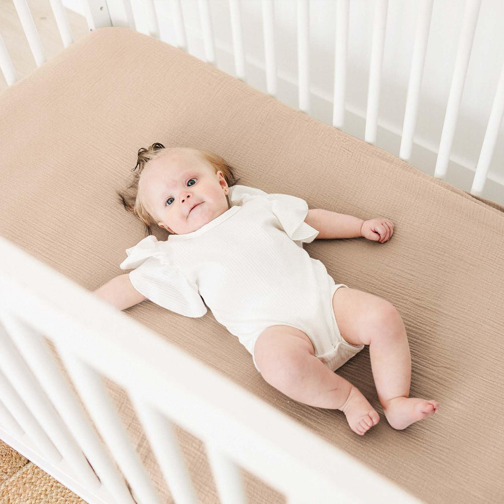 MairMore muslin crib sheet 360° elastic edge shows secure fit.
