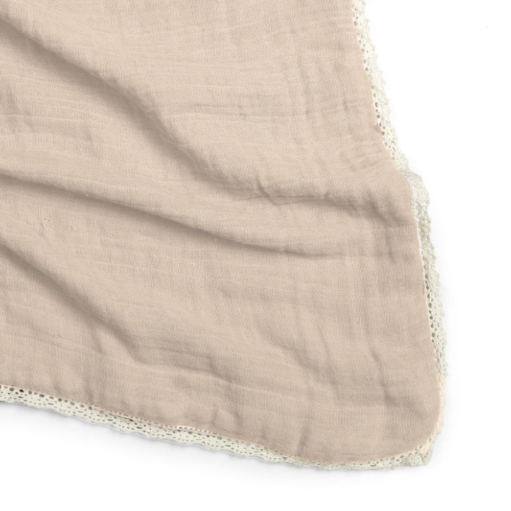 MakeMake Organics muslin blanket used as a car seat cover for shade and breathability.