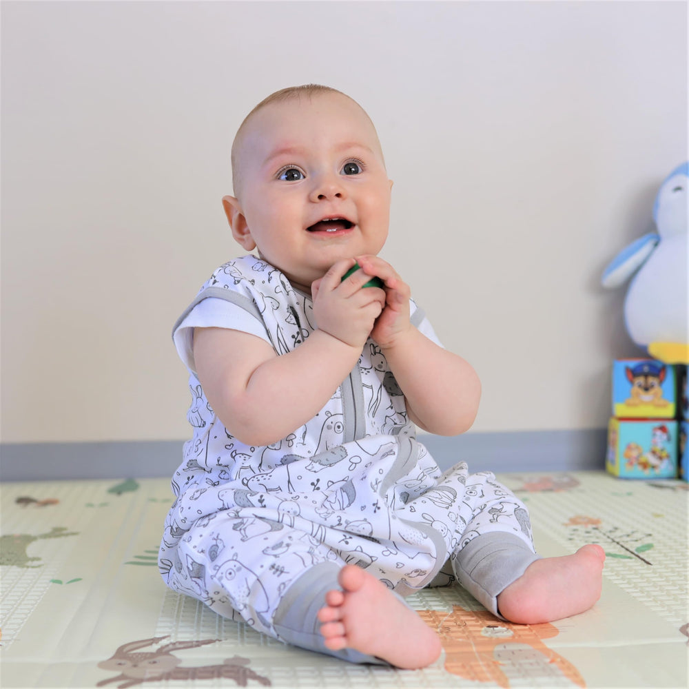Mama Cheetah wearable blanket supports crawling and early walking.