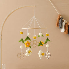Natural felt balls and wooden beads provide tactile textures for safe exploration