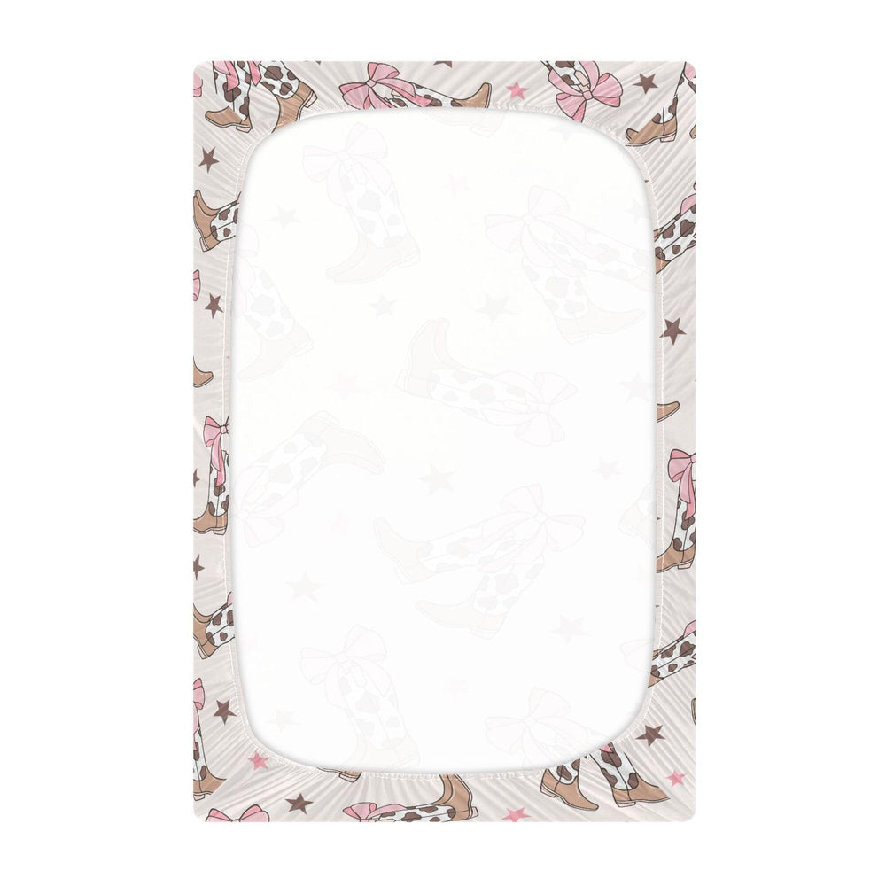 Mazeann Bows crib sheet with secure elastic band for snug fit.