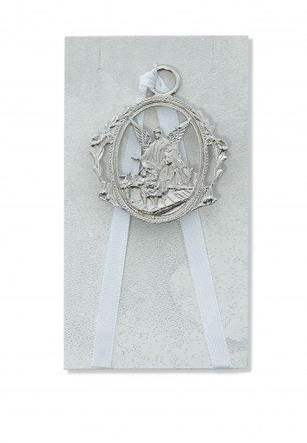McVan Guardian Angel crib medal with white ribbon for nursery decor and a sentimental keepsake.