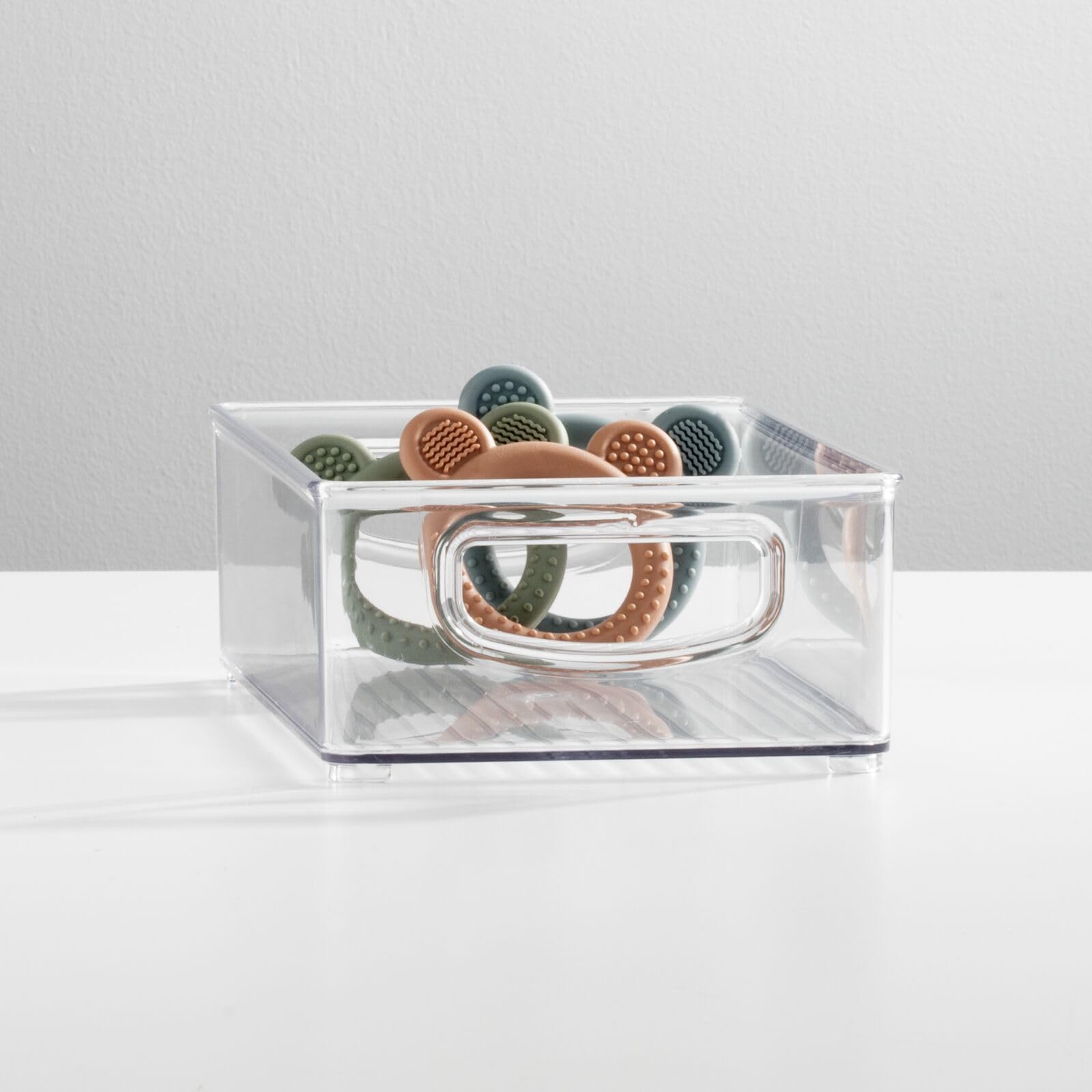 mDesign Ligne clear bin with side handles enables portable storage of bottles and formulas.