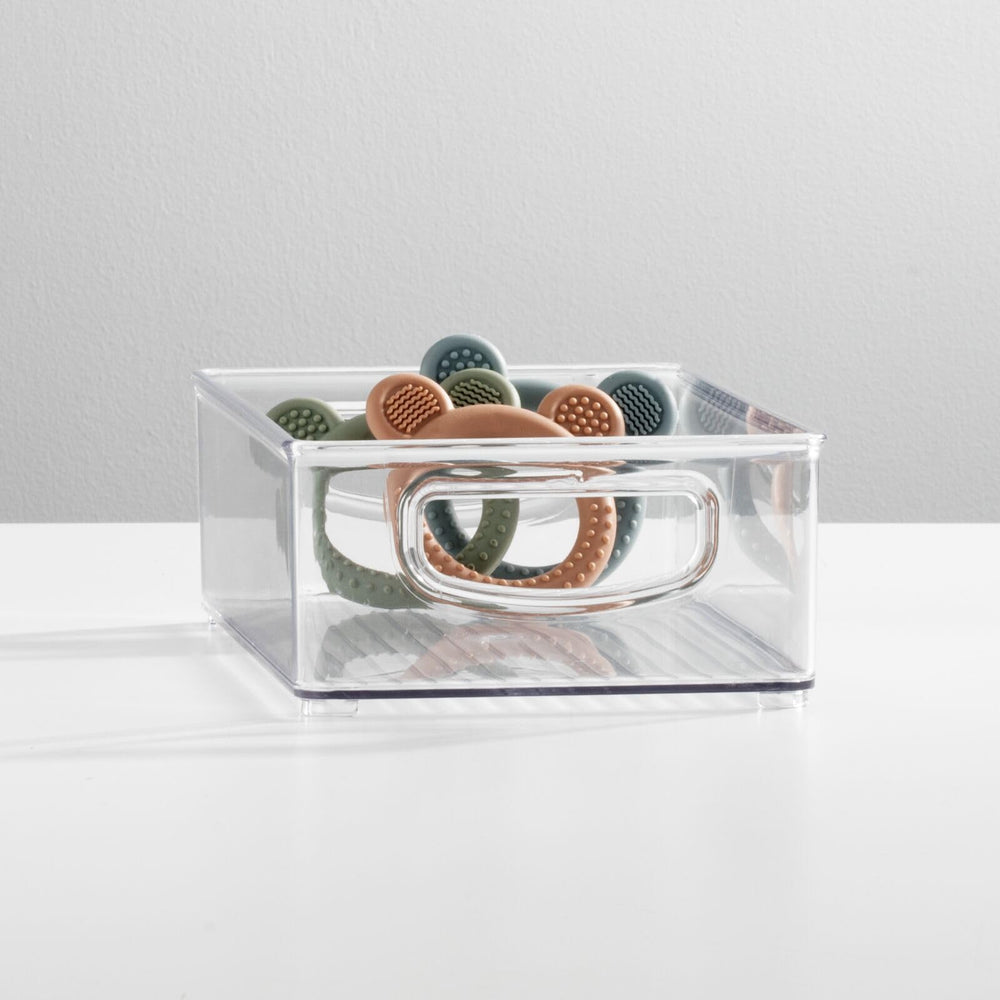 mDesign Ligne clear bin with side handles enables portable storage of bottles and formulas.