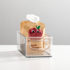 MDesign stackable clear nursery bin demonstrates versatile storage for bottles and cups.