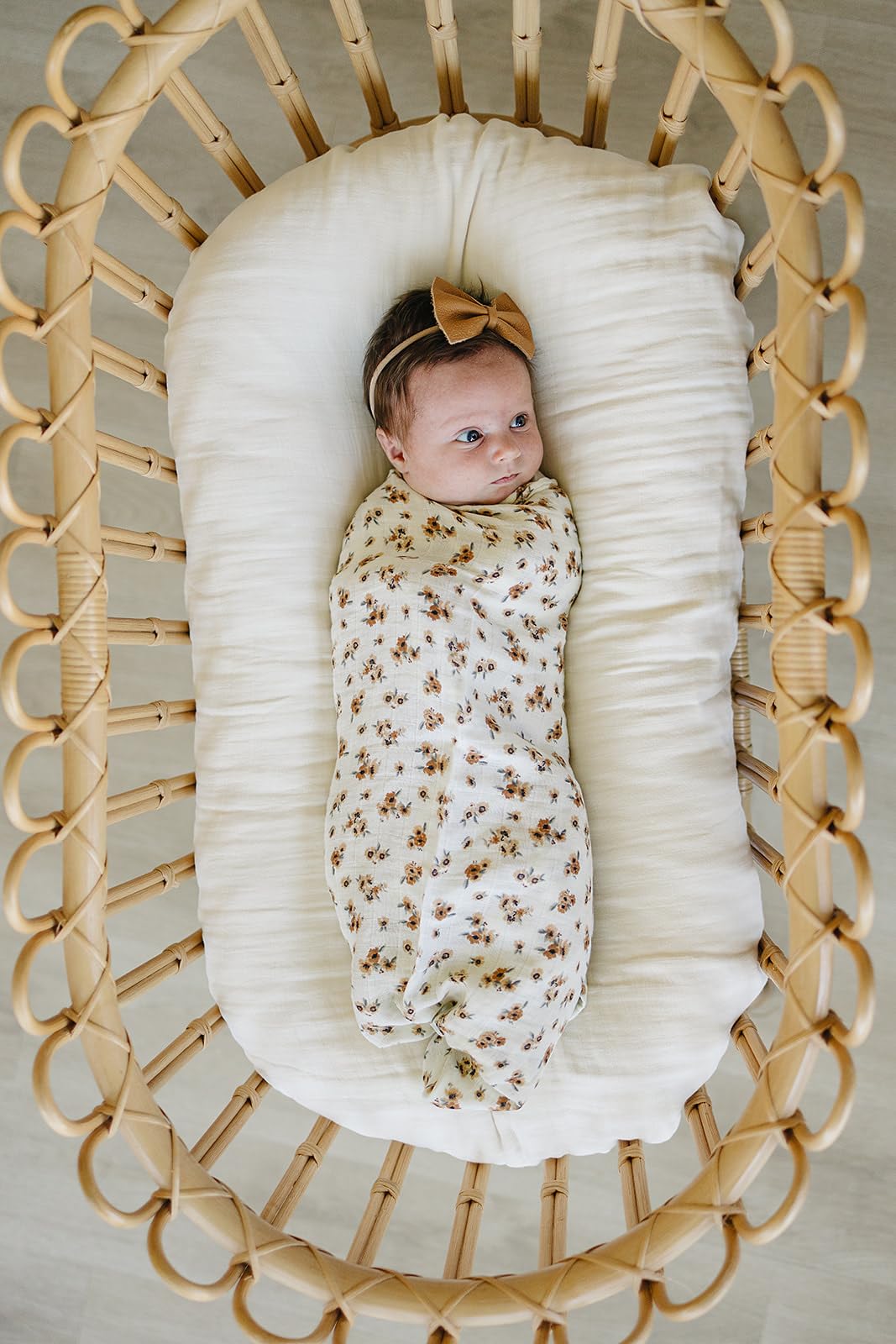 Mebie Baby Autumn Bloom swaddle draped as a light blanket for a toddler nap
