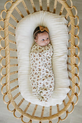 Mebie Baby Autumn Bloom swaddle draped as a light blanket for a toddler nap