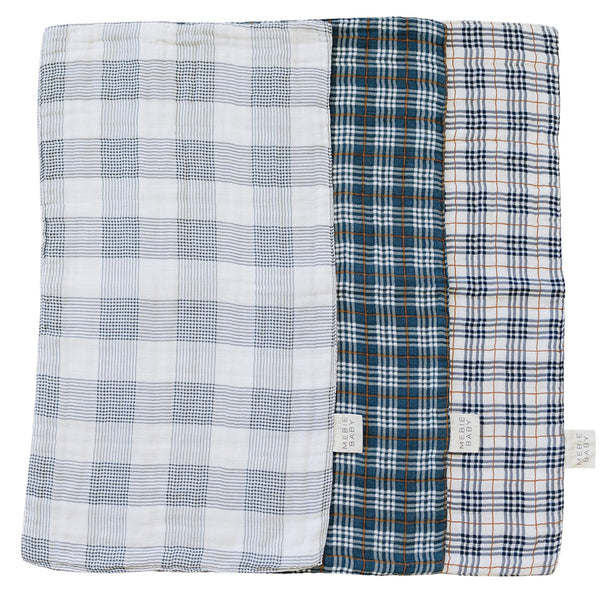 Mebie Baby burp cloth plaid muslin set shown in soft hues protecting outfits from spit-up.