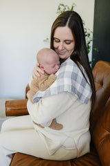 Mebie Baby burp cloth plaid muslin set displayed during changing time with drool protection.
