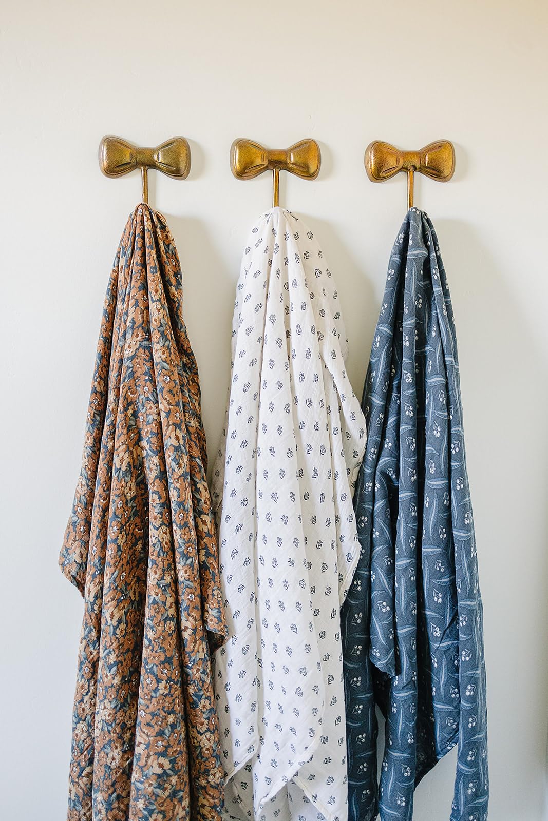 Mebie Baby Cream Berry swaddle in use for secure, gentle wrap