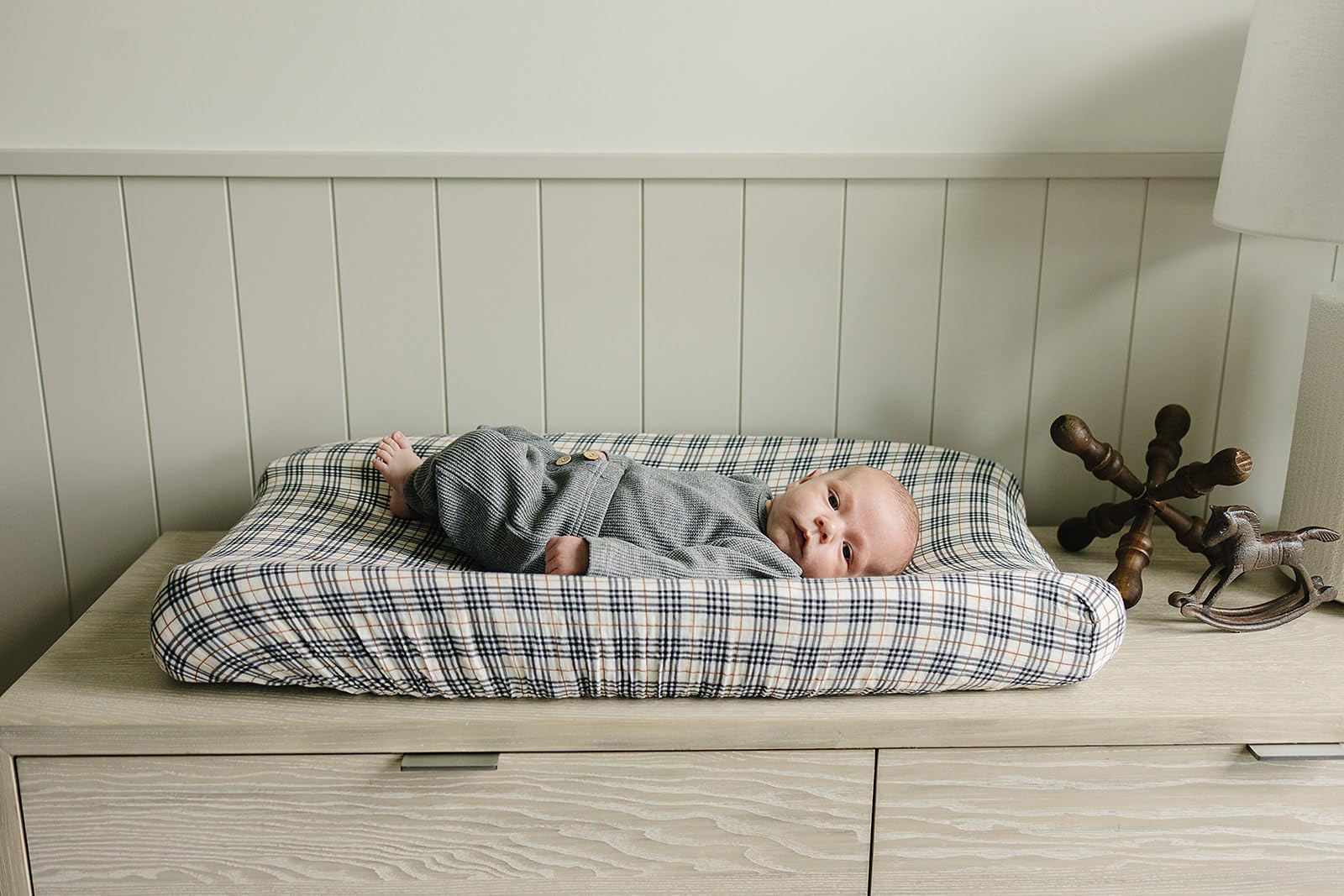 Mebie Baby designer nursery cover on changing pad showcases durable, easy-to-clean design.