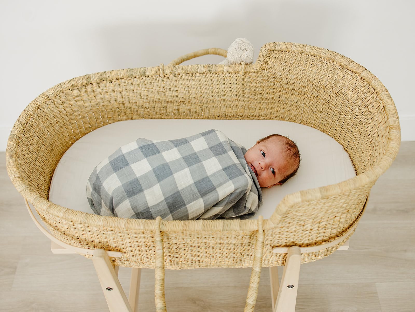 Mebie Baby Dusty Blue Gingham Swaddle used as a lightweight blanket