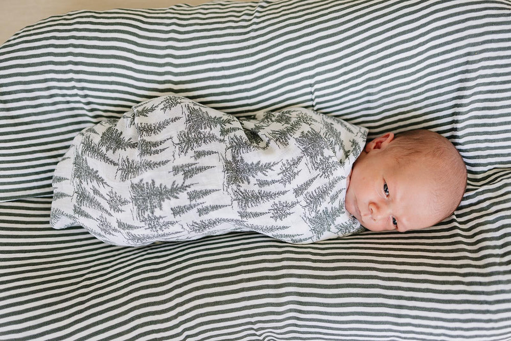 Mebie Baby forest neutral design fits modern nurseries and versatile wrapping.