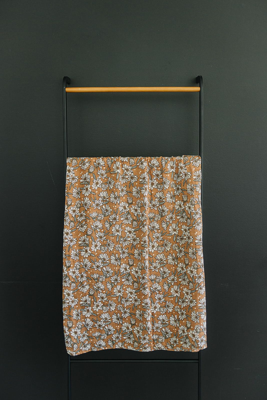 Magnolia Muslin Swaddle in a neutral nursery, stylish and versatile.