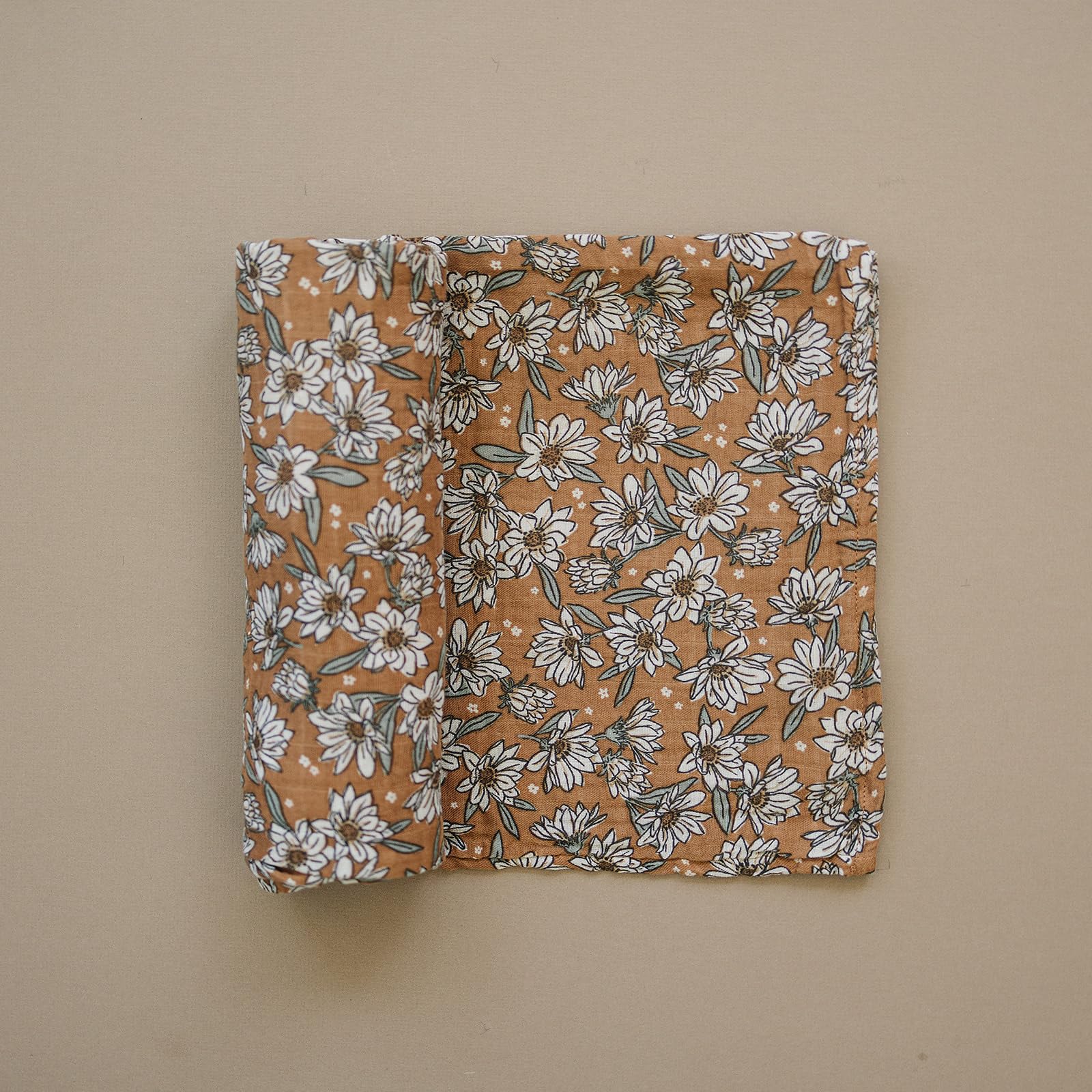Baby wrapped in Magnolia Swaddle demonstrating secure, lightweight swaddle.