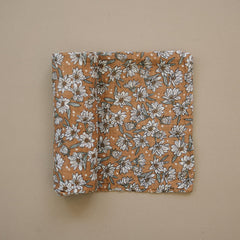 Baby wrapped in Magnolia Swaddle demonstrating secure, lightweight swaddle.