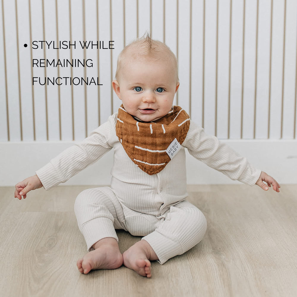 Mebie Baby muslin bib on infant, easy-on and off for quick changes.