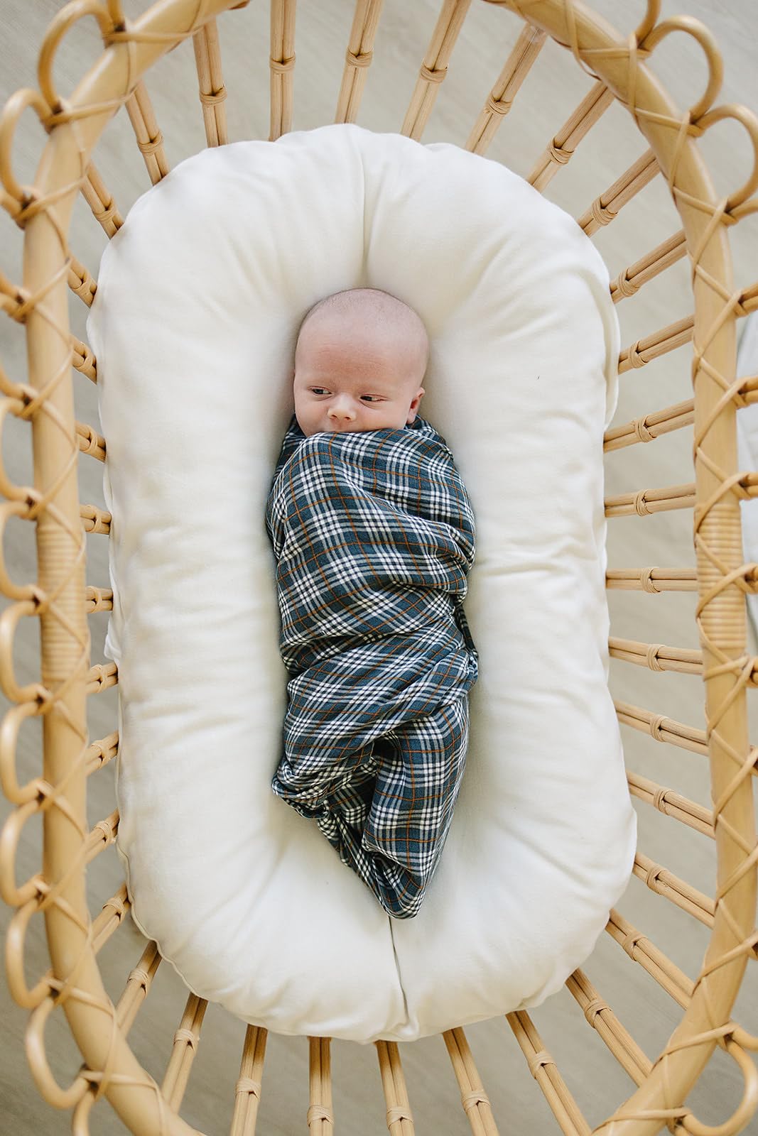 Folded Mebie Baby navy plaid swaddle blanket, versatile lightweight cover for naps.