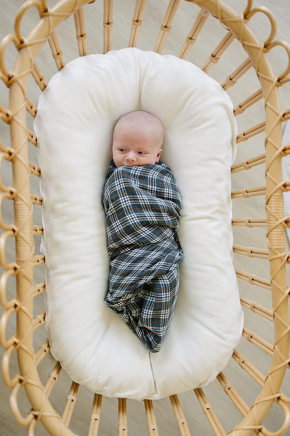 Folded Mebie Baby navy plaid swaddle blanket, versatile lightweight cover for naps.