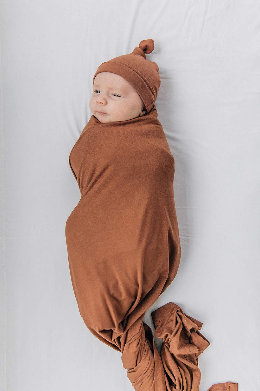 Mebie Baby newborn wrap multi-use demonstrates versatile wrap use as swaddle or light blanket.