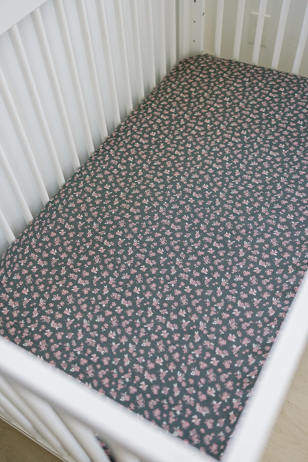 Close-up of Mebie Baby Olive Bloom muslin sheet showing soft texture.