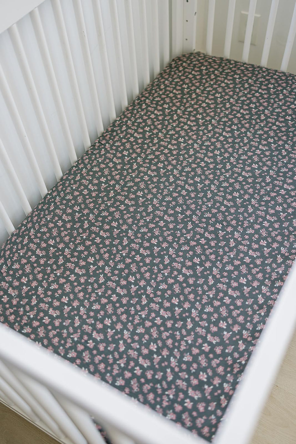 Close-up of Mebie Baby Olive Bloom muslin sheet showing soft texture.