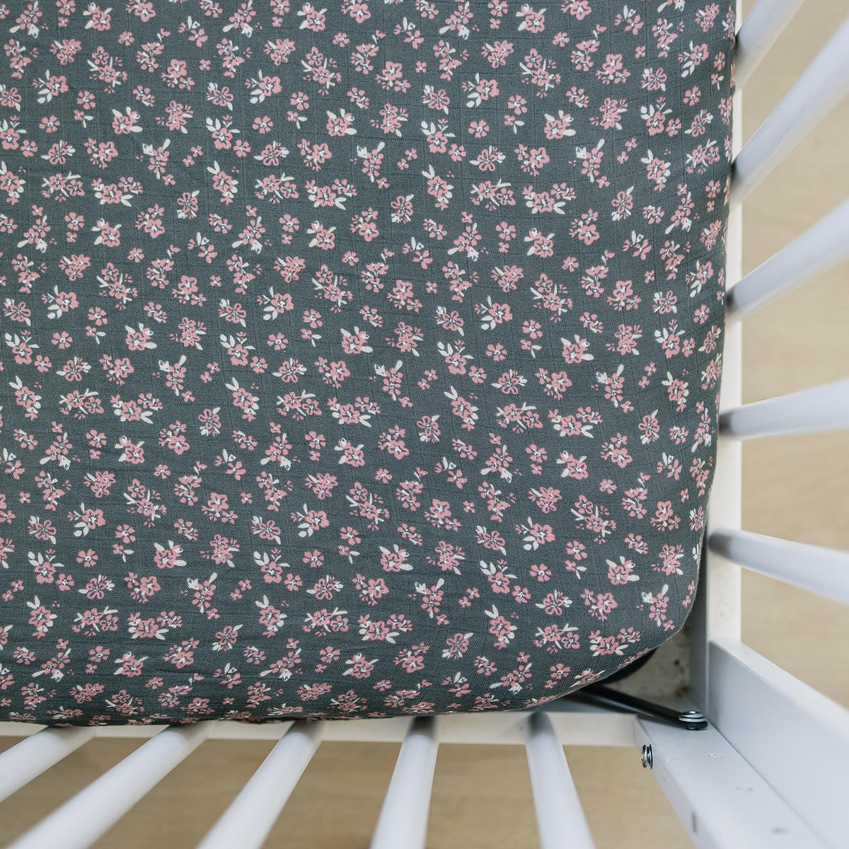 Mebie Baby Olive Bloom muslin crib sheet on a standard crib mattress, breathable.