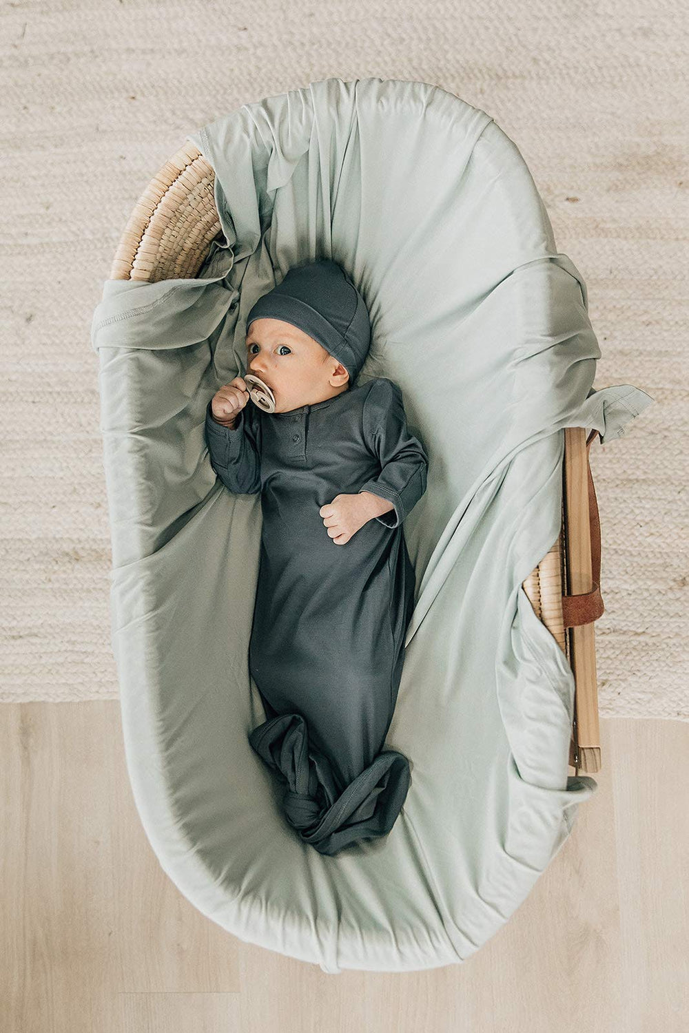 Mebie Baby Sage stretch swaddle demonstrates ample 47x47 inch size for cozy wraps