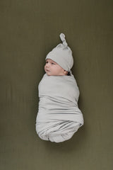 Close-up of olive stretch fabric showing bamboo softness and elasticity.
