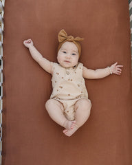 Mebie Baby stretch sheet rust folded to show compact size and color.