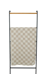 Mebie Baby taupe checkered swaddle worn by baby for cozy wrap
