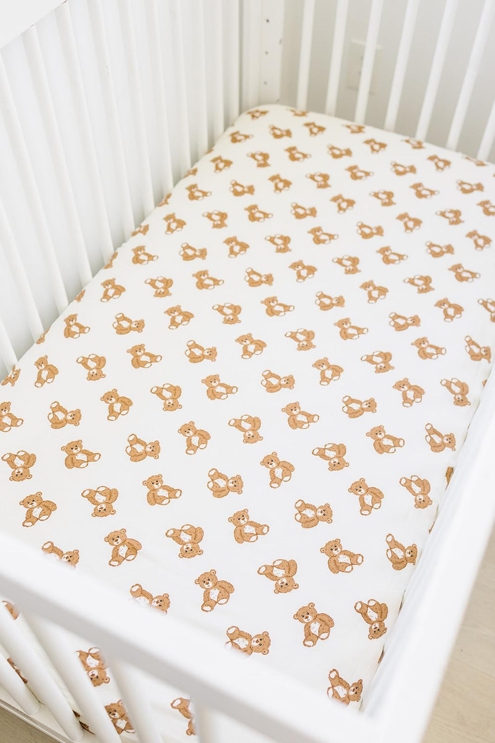 Mebie Baby Teddy Bear Muslin Sheet on a standard crib mattress for a snug fit.
