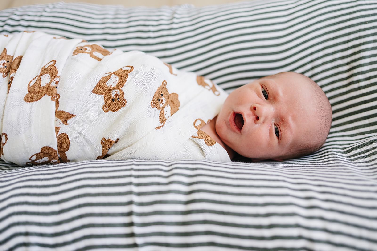 Mebie Baby Teddy Bear Muslin Swaddle in-use demonstrates versatile wrap for swaddling and lightweight blanket use.