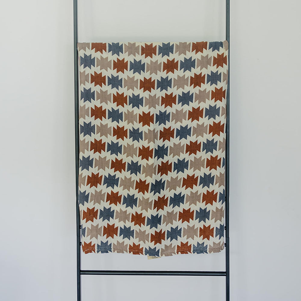 Mebie Baby Western Aztec Muslin Swaddle in use as a versatile wrap for comfort